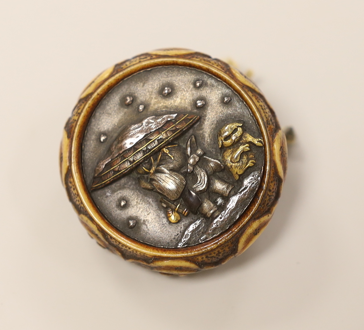 A Japanese carved stag antler and mixed metal manju netsuke, Meiji period, 4cm diameter